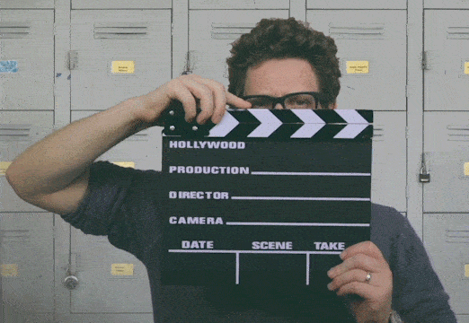 A man holding a movie clapper board.