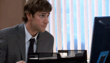 A man shakes his head at a computer.