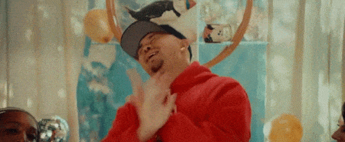 A man swipes the air to laugh at the idea of something.