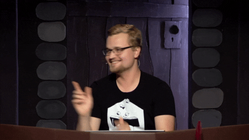 A man does a dance with thumbs up.