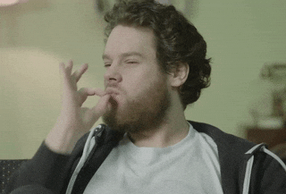 A man does a chef's kiss with his fingers.