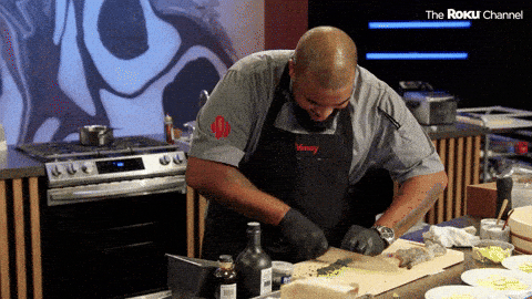 A man chops vegetables very quickly.