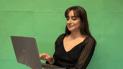 A woman types on a laptop.