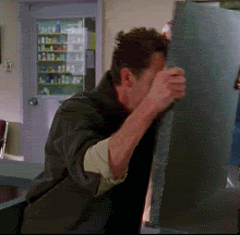 A man bangs his head on a swinging countertop.